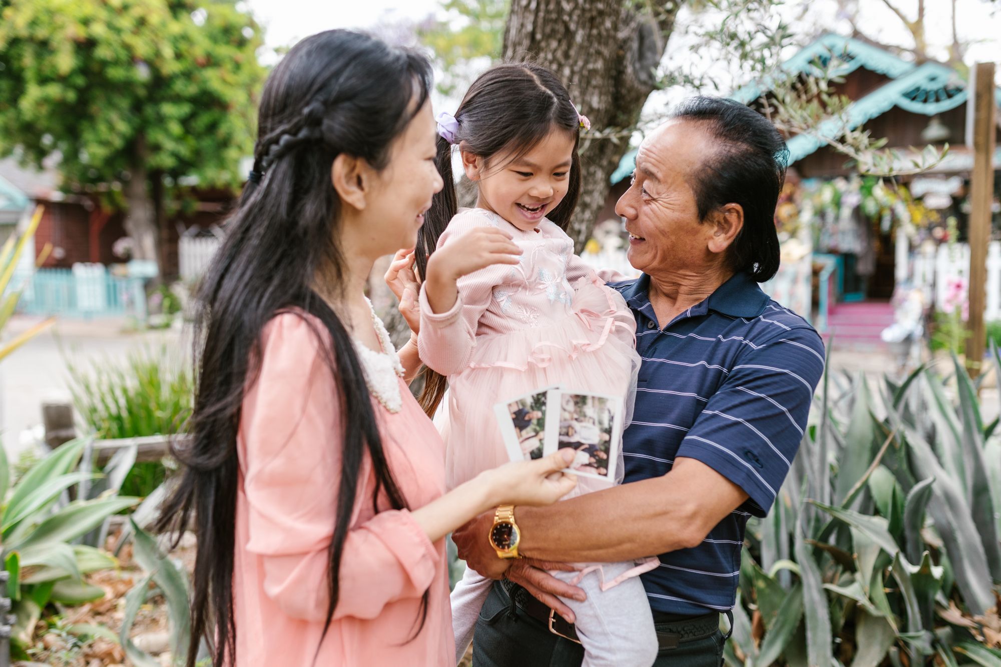 Grandparents and a child sharing a happy moment outdoors with family photographs